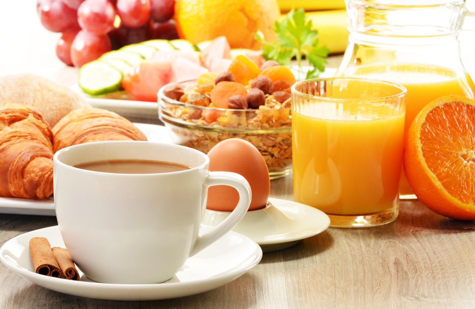Breakfast with coffee, orange juice, croissant, egg, vegetables